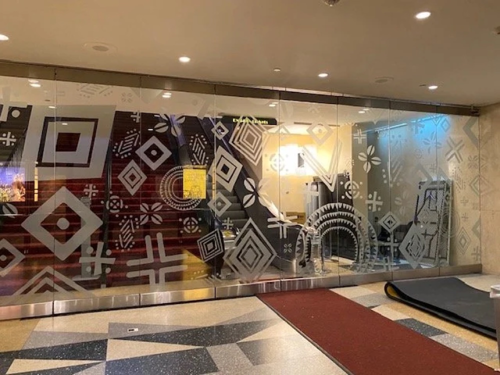 Minskoff Theatre lobby glass wall, decaled with an African-pattern motif.