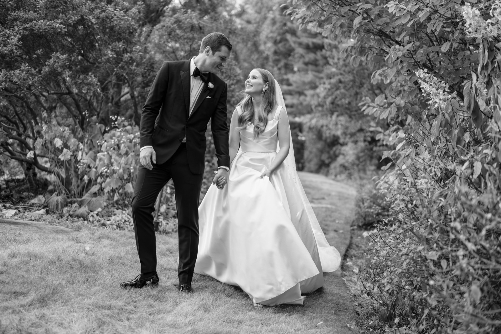 Black-and-white garden portrait of a couple.
