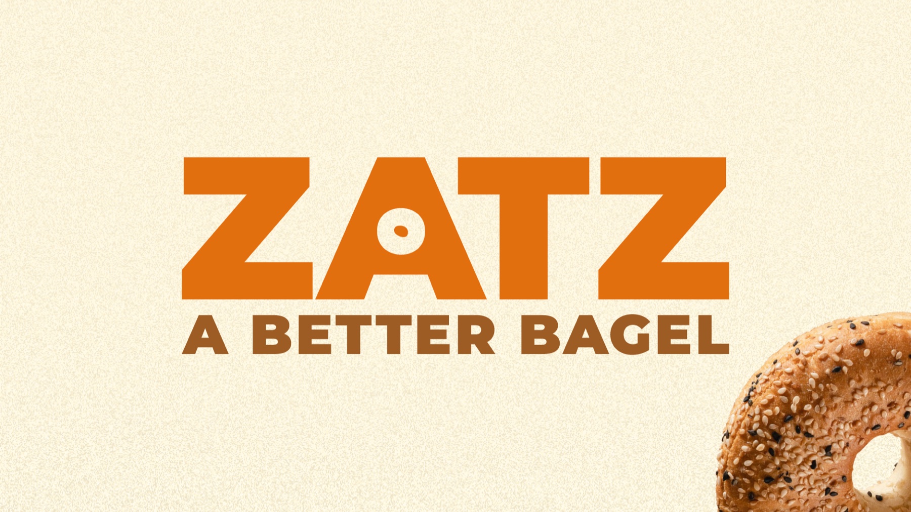 Zatz wordmark with a fresh everything bagel — brand hero shot.